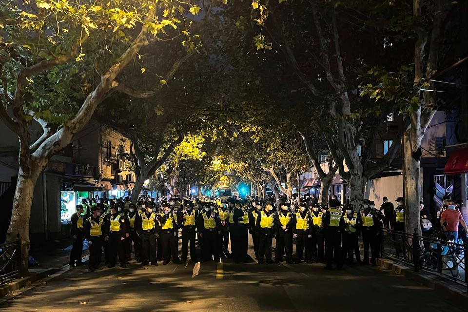 Chinese police officers block off access to a site where protesters had gathered in Shanghai on Sunday, Nov. 27, 2022. Protests against China's strict "zero-COVID" policies resurfaced in Shanghai and Beijing on Sunday afternoon, continuing a round of demonstrations that have spread across the country since a deadly apartment fire in the northwestern city of Urumqi led to questions over such rigid anti-virus measures.