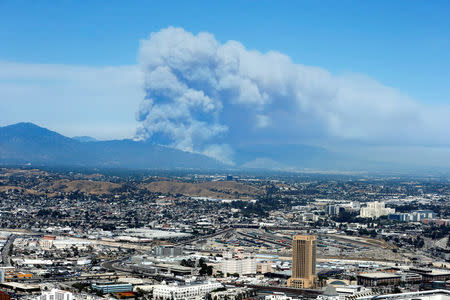 FILE PHOTO: Two wildfires burn in the San Gabriel Mountains in Azusa and Duarte behind downtown Los Angeles, California, U.S. June 20, 2016. REUTERS/Lucy Nicholson/File Photo