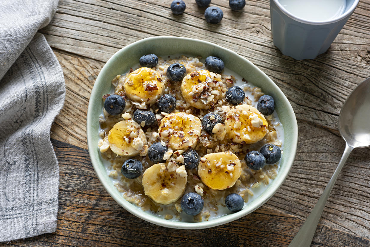 Oats and frozen berries are two budget-friendly foods that can boost your gut health. (Getty Images)