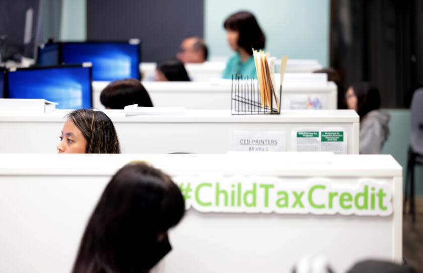 Los Angeles, California February 29, 2024-Volunteer tax preparer Lidia Sebastian helps a customer with her taxes at the Koreatown Youth + Community Center. Each winter, some 50 free tax sites pop up around the Los Angeles area. (Wally Skalij/Los Angeles Times)