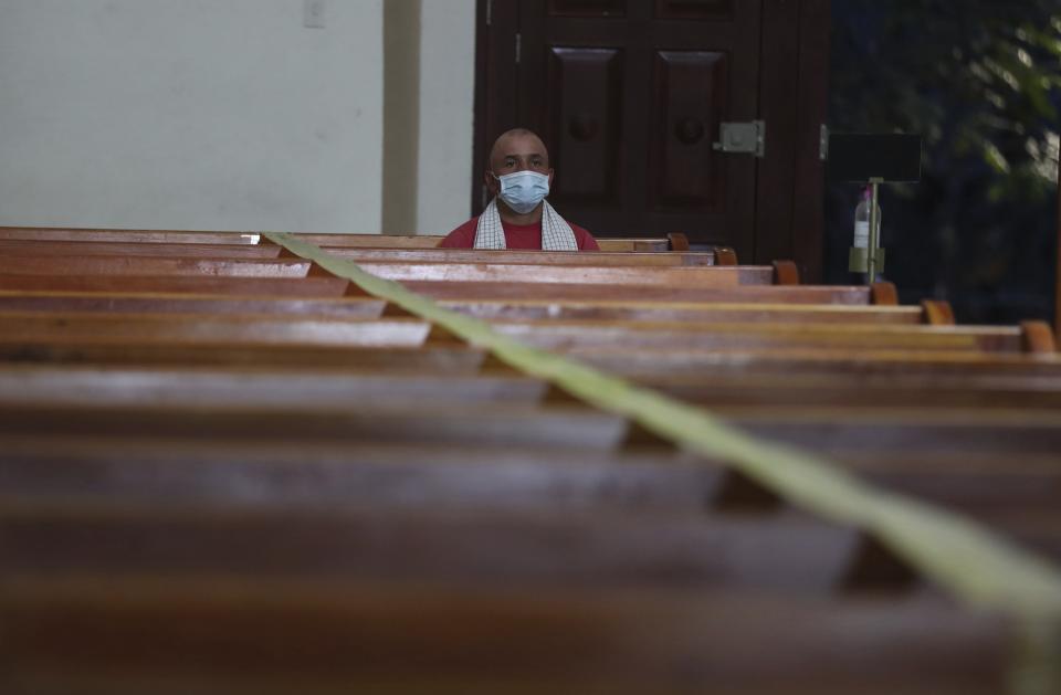 A man wearing a mask to curb the spread of the new coronavirus attends a Mass in Campohermoso, Colombia, Thursday, March 18, 2021. Campohermoso is one of two municipalities in Colombia that has not had a single case of COVID-19 since the pandemic started one year ago. (AP Photo/Fernando Vergara)