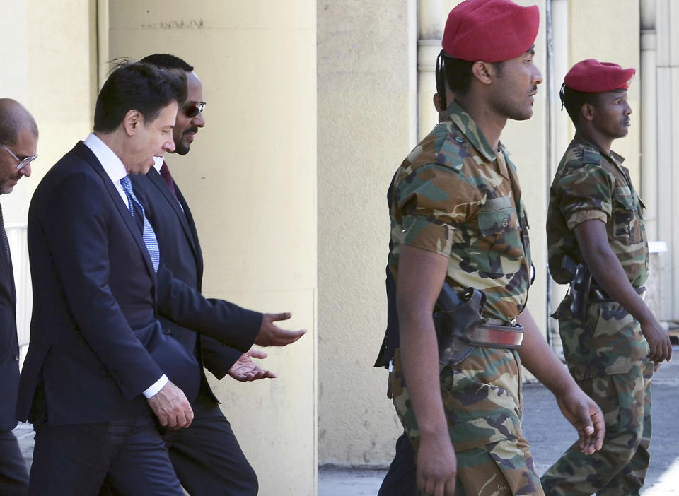 Italy's Prime Minister Giuseppe Conte, left, is welcomed by Ethiopia's Prime Minister Abiy Ahmed, second from left, upon his arrival at the airport in Addis Ababa, Ethiopia Thursday, Oct. 11, 2018. The two parties will have bilateral discussions on trade, investment, and other matters according to Ethiopia's Prime Minister's office. (AP Photo)