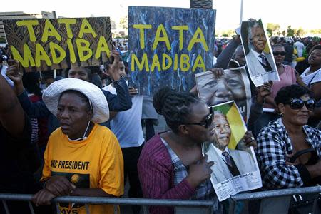 People take part in an interfaith service for former President Nelson Mandela held in front of the Town Hall on Grand Parade in Cape Town December 6, 2013. REUTERS/Mark Wessels