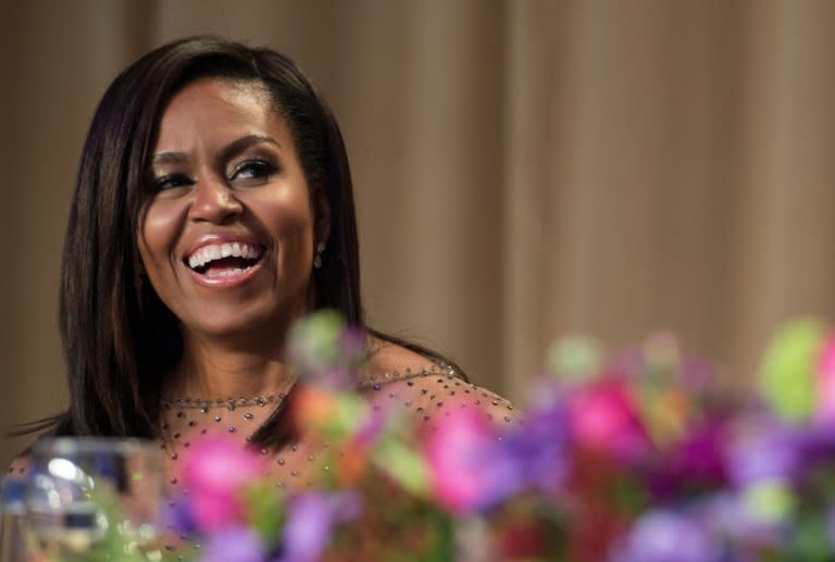 US First Lady Michelle Obama laughs at a joke by her husband President Barack Obama during the 102nd White House Correspondents' Association Dinner in Washington, DC