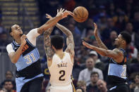 Cleveland Cavaliers' John Henson (31) knocks the ball loose from New Orleans Pelicans' Lonzo Ball (2) into the hands of Alfonzo McKinnie (28) during the first half of an NBA basketball game Tuesday, Jan. 28, 2020, in Cleveland. (AP Photo/Tony Dejak)