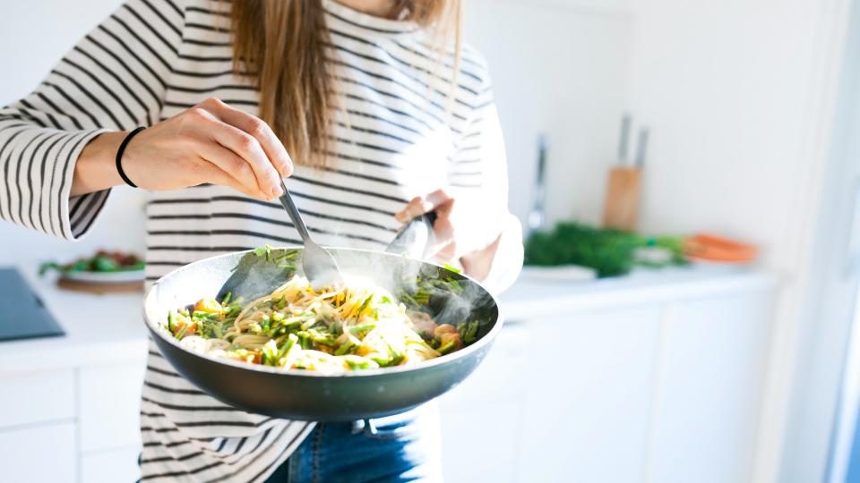 woman eating a bowl of pasta