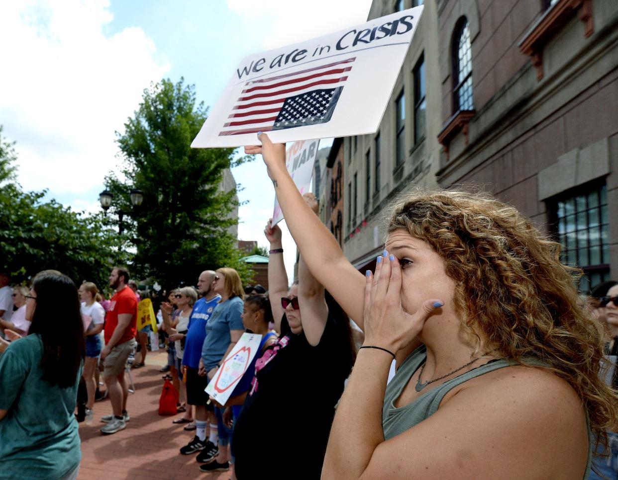 Karen Skinner of Springfield wipes away tears Saturday as she listens to a speaker talk about her experiences during the Bans Off Our Bodies Roe Reaction Rally in front of the Old State Capitol.