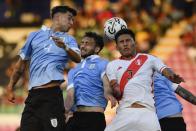 Uruguay's Mateo Ponte, left, heads the ball challenged by Peru's Alejandro Posito during South America's under-23 pre-Olympic tournament soccer match at the Misael Delgado stadium in Valencia, Venezuela, Tuesday, Jan. 30, 2024. (AP Photo/Matias Delacroix)
