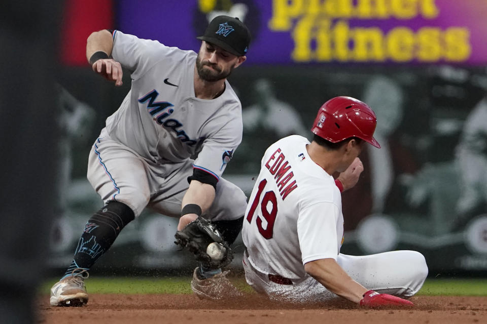 St. Louis Cardinals' Tommy Edman (19) steals second ahead of the tag from Miami Marlins second baseman Jon Berti during the fifth inning of a baseball game Tuesday, June 28, 2022, in St. Louis. (AP Photo/Jeff Roberson)