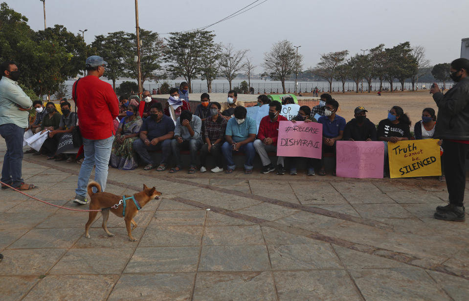 Activists participate in a silent protest against the arrest of environmental activist Disha Ravi in Hyderabad, India, Saturday, Feb. 20, 2021. The 22-year-old Indian climate activist who is facing sedition charges for her alleged role in the creation of an online document intended to help amplify farmer protests did not get bail Saturday after a court said it will reserve its order for next week. (AP Photo/Mahesh Kumar A.)