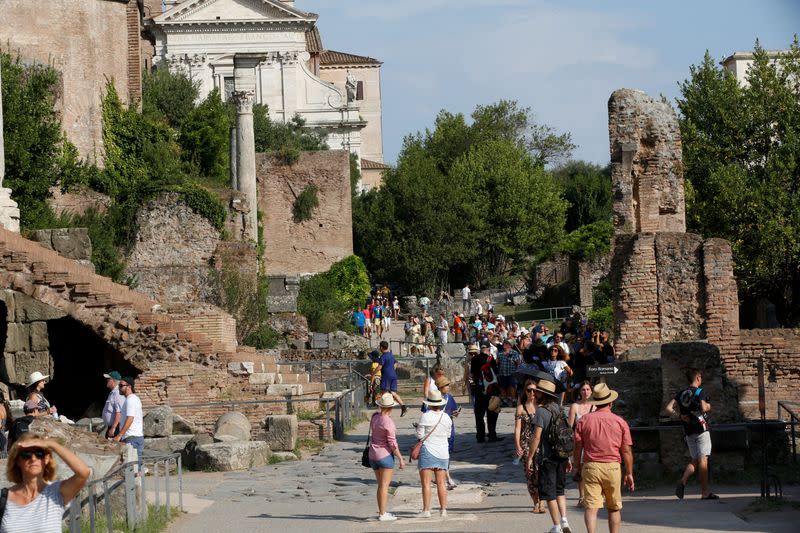 FILE PHOTO: Tourists walk along the Roman Forum
