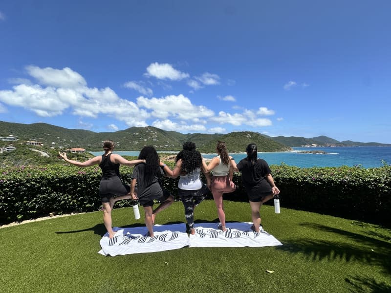 4 people doing yoga with view of the sea from Villa Cin Cin in St. John, US Virgin Islands