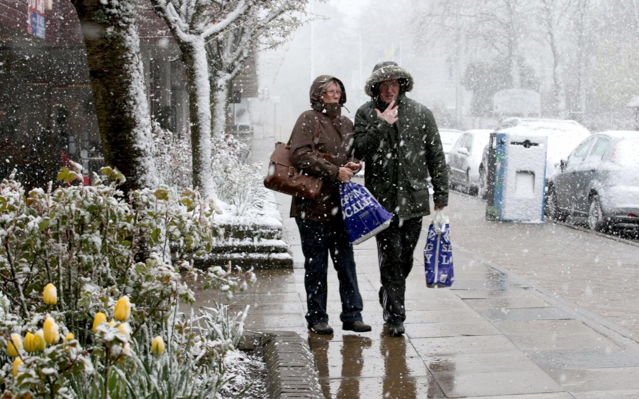 Shoppers in an April snow shower in Aviemore this week - but warmer weather is on the way - PA