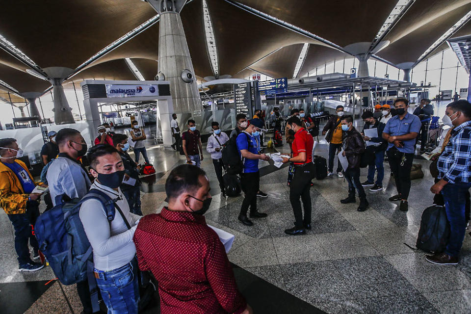 Travellers are seen with their luggage at the Kuala Lumpur International Airport October 17, 2021. ― Picture by Hari Anggara