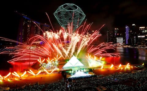 Fireworks explode over Marina Bay during New Year's Eve celebrations in Singapore - Credit: Reuters