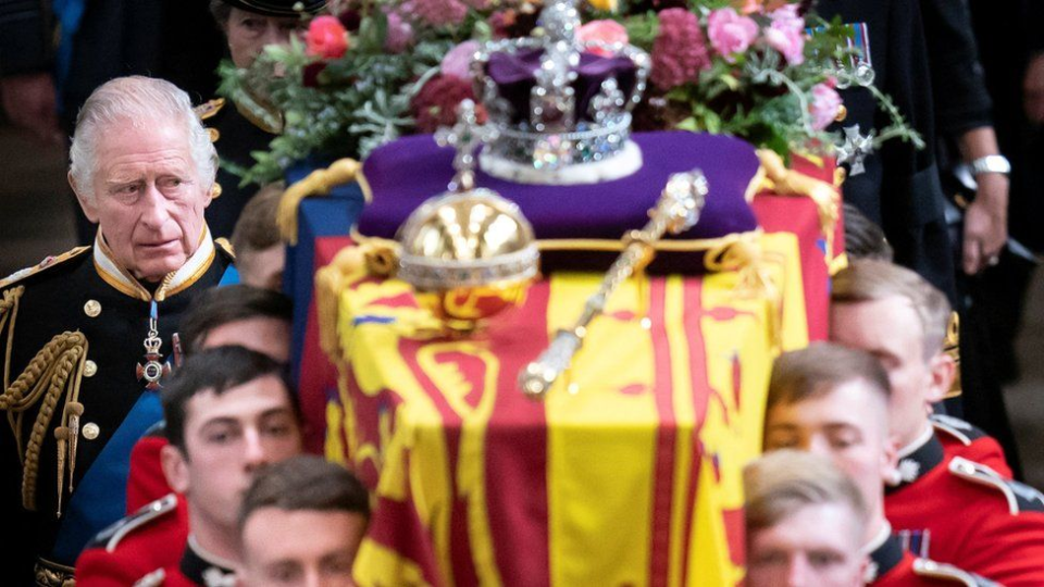 King Charles III walks behind the coffin of his mother, Queen Elizabeth II.