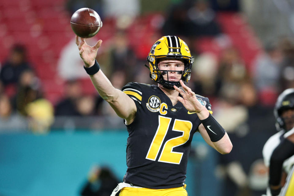 Dec 23, 2022; Tampa, Florida; Missouri Tigers quarterback Brady Cook (12) throws a pass against the Wake Forest Demon Deacons during the first quarter in the 2022 Gasparilla Bowl at Raymond James Stadium. Nathan Ray Seebeck-USA TODAY Sports