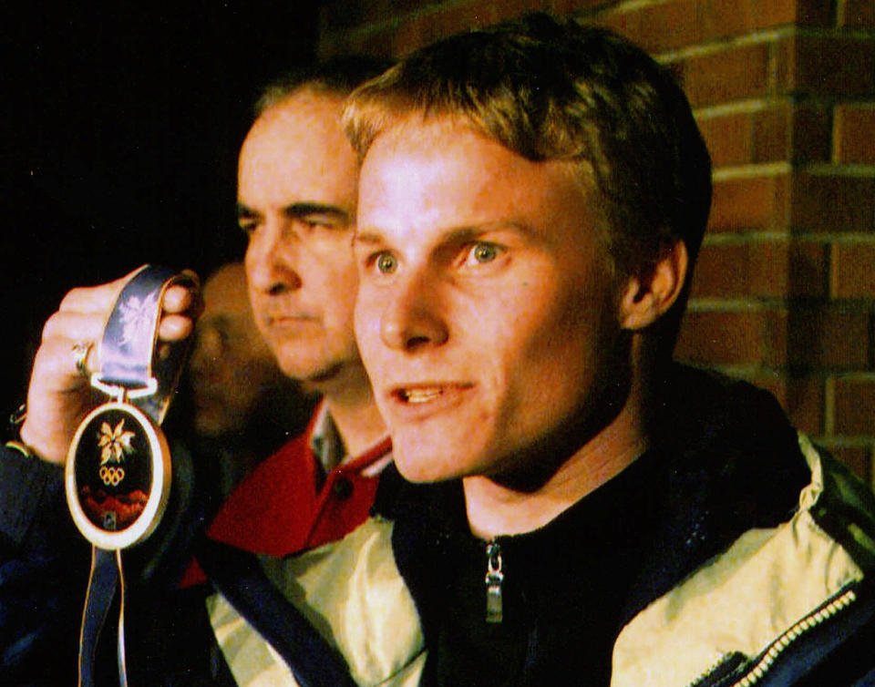 Ross Rebagliati shows his gold medal to reporters in Nagano after he was questioned by police about his use of marijuana. (AP Photo/Nikkan Sports)