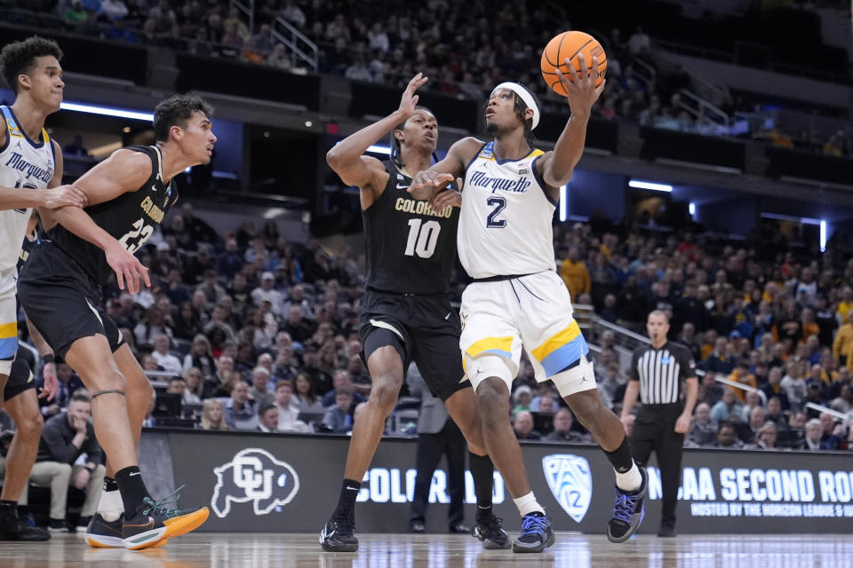Marquette's Chase Ross (2) shoots over Colorado's Cody Williams (10) and Tristan da Silva (23) during the first half of a second-round college basketball game in the NCAA Tournament, Sunday, March 24, 2024 in Indianapolis. (AP Photo/Michael Conroy)