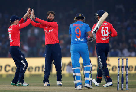 Cricket - India v England - First T20 International - Green Park Stadium, Kanpur, India - 26/01/17. England's Moeen Ali and captain Eoin Morgan celebrate the wicket of India's Manish Pandey. REUTERS/Danish Siddiqui