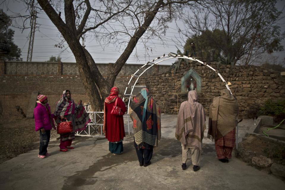 In this Sunday, Feb. 16, 2014, photo, Pakistani women, who live nearby, pray before walking into the church to attend a Sunday mass, at St. Joseph’s Hospice, in Rawalpindi, Pakistan. Mohammed Aqeel spent weeks at home in Pakistan waiting for death after suffering a debilitating spinal cord injury in a car crash before friends suggested he come to St. Joseph’s Hospice on the outskirts of the capital, Islamabad. Now 13 years later, his life and those of some 40 others who live on its grounds might be changed forever as this hospital of last resort faces closure over its rising debts. (AP Photo/Muhammed Muheisen)