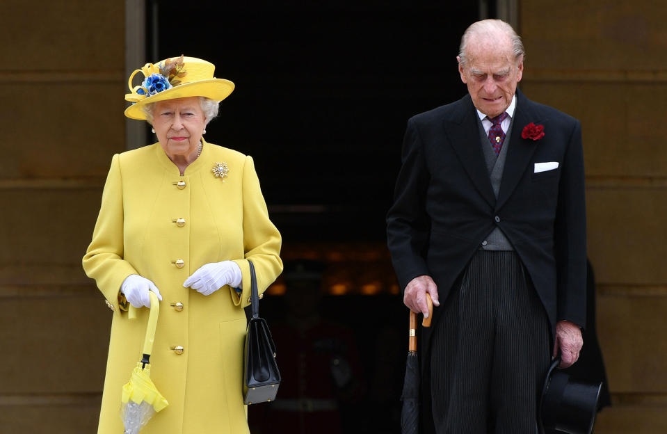 <p>Queen Elizabeth II and Prince Philip, Duke of Edinburgh observe a minute’s silence in honour of the victims of the attack at Manchester Arena at the start of a garden party at Buckingham Palace on May 23, 2017 in London, England. (Dominic Lipinski – WPA Pool/Getty Images) </p>