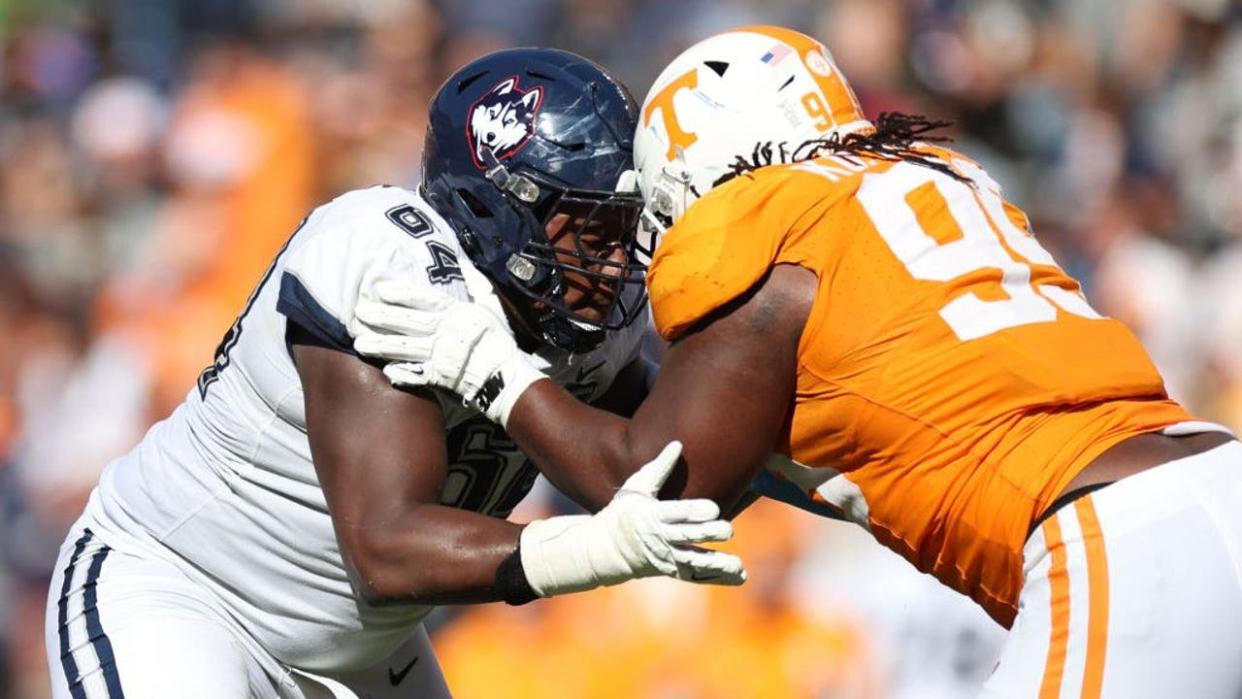 <div>KNOXVILLE, TENNESSEE - NOVEMBER 04: Christian Haynes #64 of the Connecticut Huskies goes head to head against Kurott Garland #99 of the Tennessee Volunteers at Neyland Stadium on November 04, 2023 in Knoxville, Tennessee. Tennessee won the game 59-3.</div> <strong>(Donald Page / Getty Images)</strong>