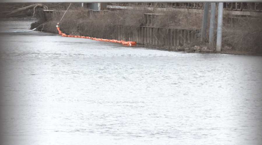 A boom deployed on the Grand River in Lansing to clean-up environmental contamination from creosote. (WLNS)
