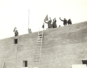 ICBC Board Chair Joseph Carrier, President Anthony Fusco, and Villa Colombo Toronto construction superintendent Jim Cirillo proudly raised the Canadian and Italian flags for the roof topping ceremony marking the completion of the external structure. (April 1975)