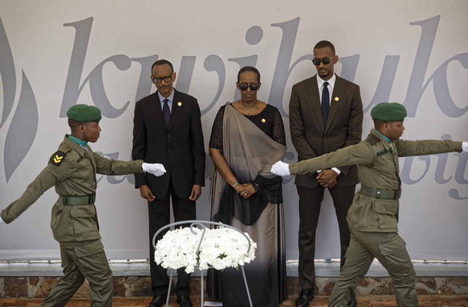 Rwanda's President Paul Kagame, center-left, First Lady Jeannette Kagame, center, and son Ivan Cyomoro Kagame, right, prepare to lay a wreath at the Kigali Genocide Memorial in Kigali, Rwanda Sunday, April 7, 2019. Rwanda is commemorating the 25th anniversary of when the country descended into an orgy of violence in which some 800,000 Tutsis and moderate Hutus were massacred by the majority Hutu population over a 100-day period in what was the worst genocide in recent history. (AP Photo/Ben Curtis)