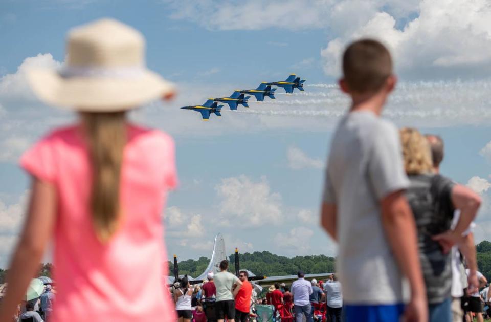 Two children watch as the U.S. Navy Blue Angels fly during an airshow June 11, 2022, in St. Louis. The Blue Angels team has flown for over 500 million fans since its creation in 1946 and will take part in an airshow Saturday, May 13, and Sunday, May 14, on Scott Air Force Base.