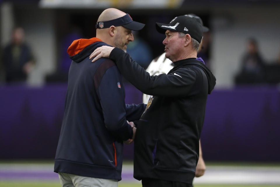 Chicago Bears head coach Matt Nagy, left, talks with Minnesota Vikings head coach Mike Zimmer, right, before an NFL football game, Sunday, Jan. 9, 2022, in Minneapolis. (AP Photo/Bruce Kluckhohn)