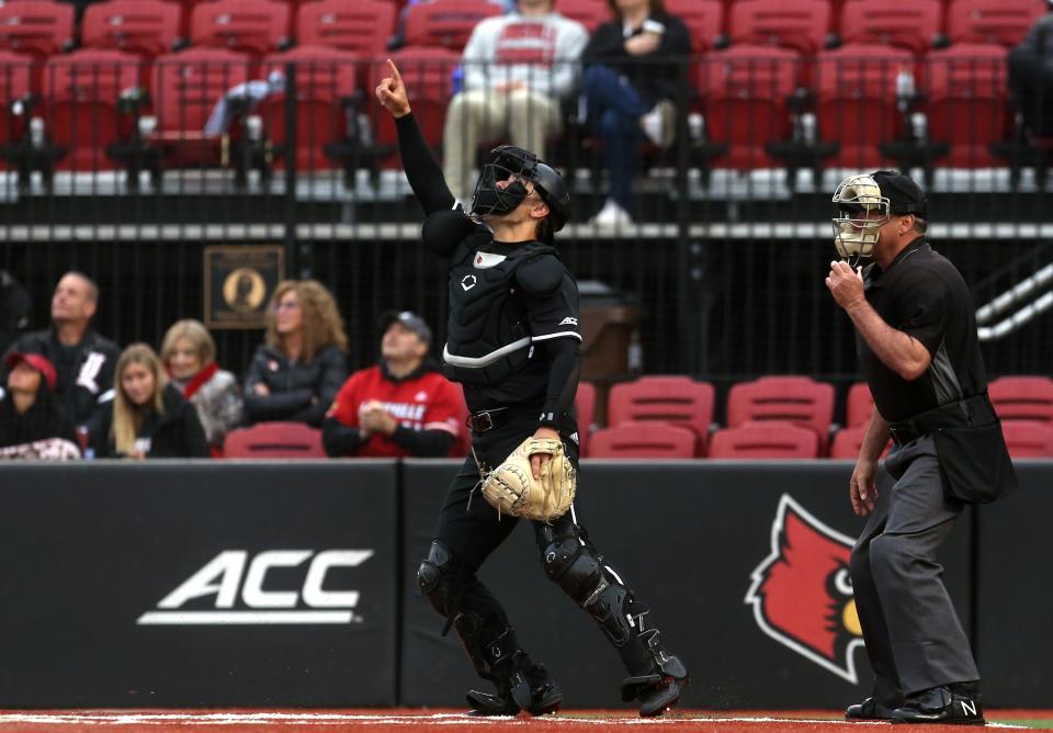 Louisville’s Jack Payton shows where the batter hit the ball up in the air at home against Boston College.April 6, 2023