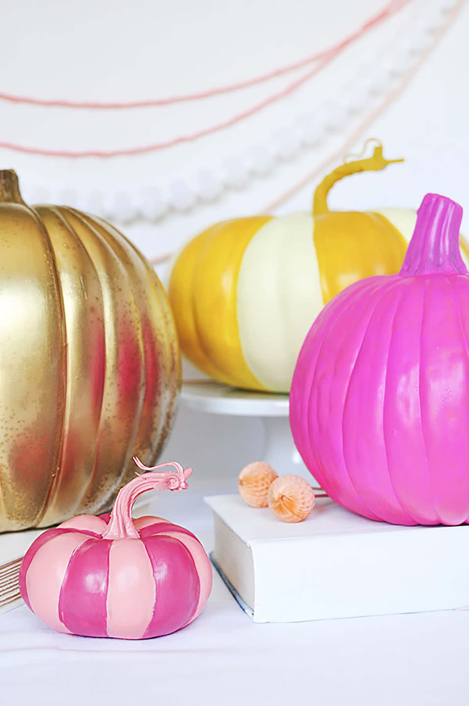 <p>Think outside the box when it comes to fall colors. Painting pumpkins bright pink or gold is also a fun craft for the kids.</p><p><strong>Get the tutorial at <a rel="nofollow noopener" href="https://www.delineateyourdwelling.com/diy-peppy-pumpkins/" target="_blank" data-ylk="slk:Delineate Your Dwelling;elm:context_link;itc:0;sec:content-canvas" class="link ">Delineate Your Dwelling</a>.</strong> </p>