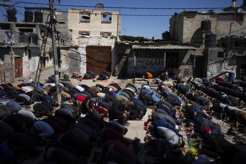 Palestinians perform the first Friday prayers of the Muslim holy month of Ramadan near the ruins of a destroyed mosque by the Israeli airstrikes in Rafah, Gaza Strip, Friday, March 15, 2024. (AP Photo/Fatima Shbair)