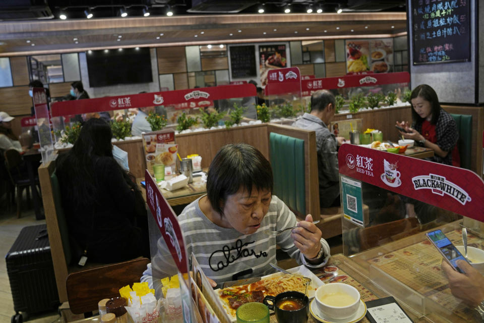 Customers have lunch in a restaurant in Hong Kong, Monday, Nov. 29, 2021. The new omicron variant was found in Hong Kong, Belgium and Tel Aviv. The European Union, the United States and Britain imposed curbs on travel from Africa. Israel banned entry by foreigners. (AP Photo/Kin Cheung)
