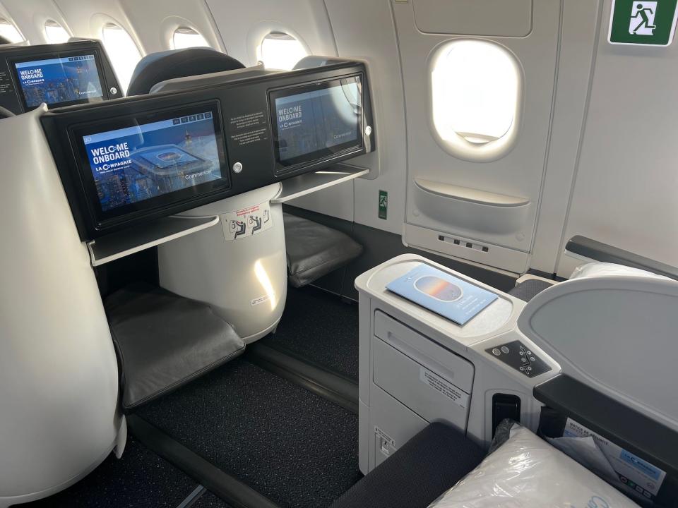 Flying on La Compagnie all-business class airline from Paris to New York — the exit row seat.