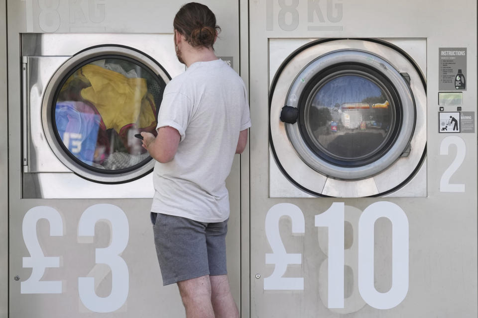 Amended prices are seen on a self-service laundromat in Manchester, England, Tuesday, Sept. 7, 2022. This was the year war returned to Europe, and few facets of life were left untouched. Russia’s invasion of its neighbor Ukraine unleashed misery on millions of Ukrainians, shattered Europe’s sense of security, ripped up the geopolitical map and rocked the global economy. The shockwaves made life more expensive in homes across Europe, worsened a global migrant crisis and complicated the world’s response to climate change. (AP Photo/Jon Super)