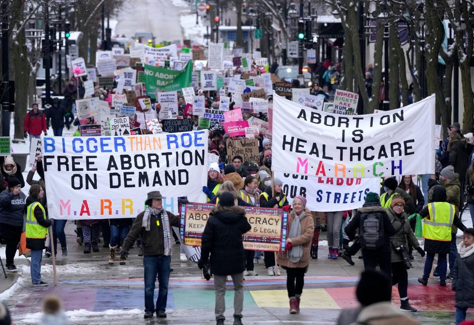 People march down State Street to the Capitol during the National Women's March marking 50th anniversary of the Roe v. Wade decision, in Madison on Sunday, Jan. 22, 2023.