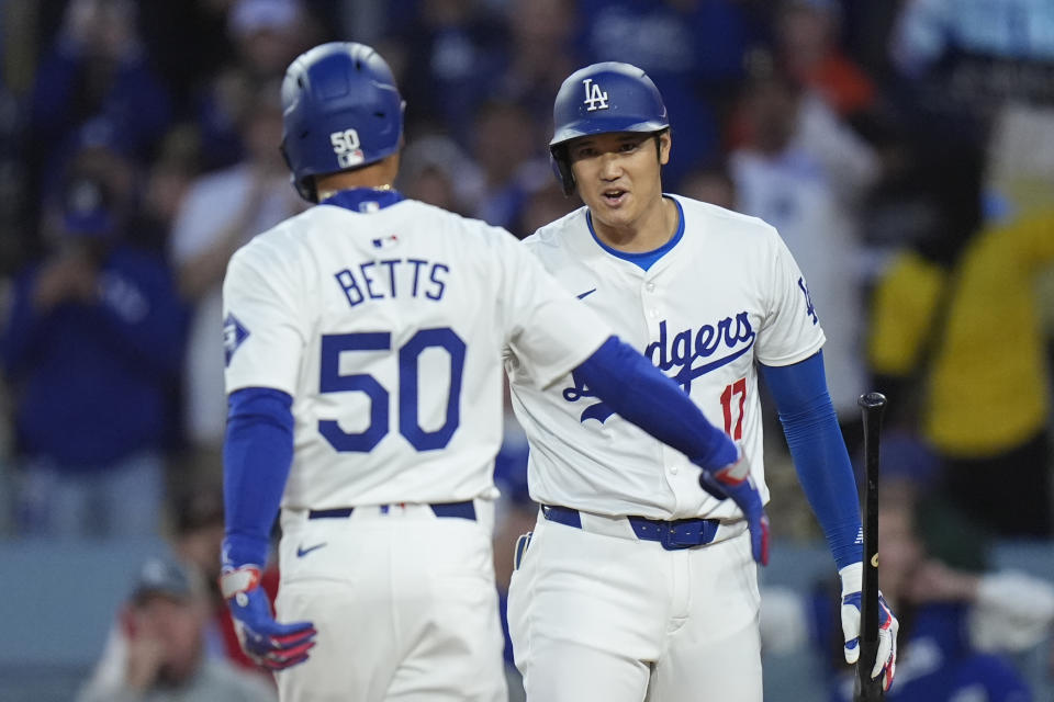 Los Angeles Dodgers' Mookie Betts (50) celebrates his home run with Shohei Ohtani (17) during the first inning of a baseball game against the St. Louis Cardinals Friday, March 29, 2024, in Los Angeles. (AP Photo/Jae C. Hong)