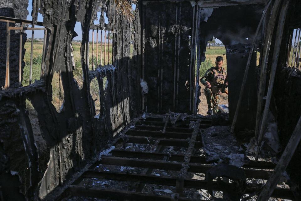 An Iraqi fighter inspects the site of an Islamic State group attack north of Baghdad in May 2020. <a href="https://media.gettyimages.com/id/1211657465/photo/topshot-iraq-conflict-is.jpg?s=1024x1024&w=gi&k=20&c=s34V40b5F3hAhyP1ZlD-BjZRPY6MdKZxgDoUmPzBCL0=" rel="nofollow noopener" target="_blank" data-ylk="slk:Ahmad Al-Rubaye/AFP via Getty Images;elm:context_link;itc:0;sec:content-canvas" class="link ">Ahmad Al-Rubaye/AFP via Getty Images</a>