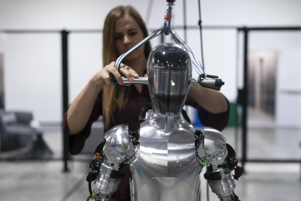 AI engineer Jenna Reher works on the humanoid robot Figure 01 at Figure AI's test facility in Sunnyvale, California, on October 3, 2023.  (AP Photo/Jae C. Hon, File)