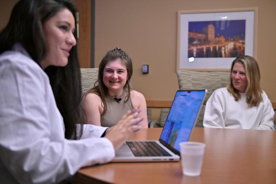 Alexis Bogan and her mother Pamela Bogan react to hearing a recreation of her lost voice from a prompt typed by Dr. Fatima Mirza. AP Photo/Josh Reynolds