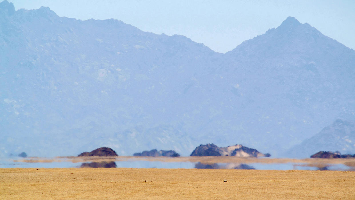  When layers of air at different temperatures cause light rays to bend, a mirage occurs and the blue sky appears as a pool of water. 