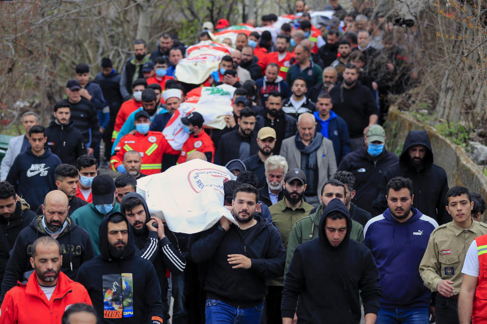 People carry the coffins of paramedics who were killed in an Israeli airstrike, during a funeral procession in Hebbariye village, south Lebanon, Wednesday, March 27, 2024. The Israeli airstrike on a paramedic center linked to a Lebanese Sunni Muslim group killed several people. The strike was one of the deadliest single attacks since violence erupted along the Lebanon-Israel border more than five months ago. (AP Photo/Mohammed Zaatari)