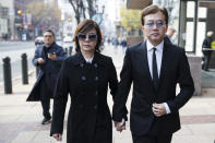 Sun Peng, right, and Di Ying walk from the federal courthouse in Philadelphia, Monday, Nov. 19, 2018. Their son An-Tso Sun, a Taiwanese exchange student accused of threatening to "shoot up" his high school near Philadelphia has been spared additional time in prison but will be deported. (AP Photo/Matt Rourke)