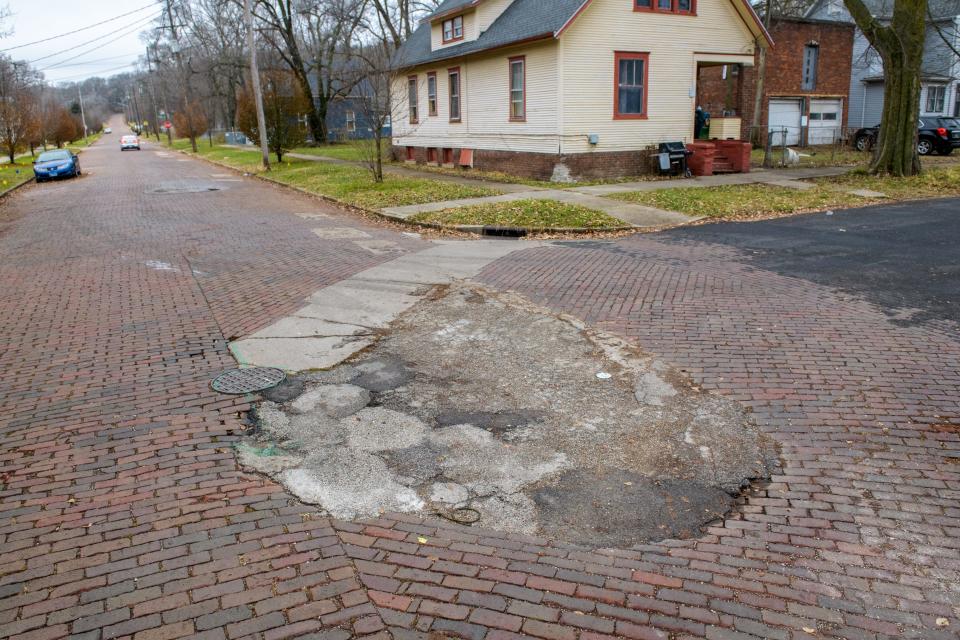 A large area brick pavers apparently has been repaired several times at the intersection of N. Sand Street and W. Aiken Avenue in South Peoria.