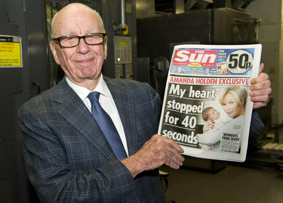 Murdoch holds a copy of The Sun, Feb. 25, 2012 (Getty Images)