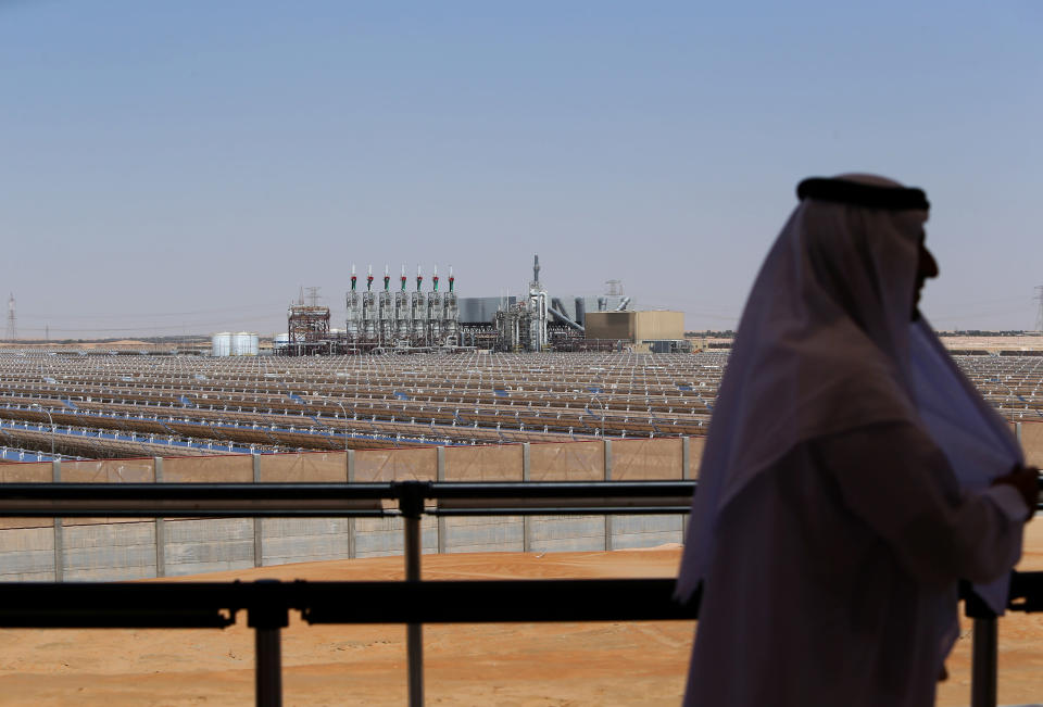 An Emarati man stands on a balcony overlooking the Shams 1, Concentrated Solar power (CSP) plant, in al-Gharibiyah district on the outskirts of Abu Dhabi, on March 17, 2013 during the inauguration of the facility. Oil-rich Abu Dhabi officially opened the world's largest Concentrated Solar Power (CSP) plant, which cost $600 million to build and will provide electricity to 20,000 homes. (Photo credit: MARWAN NAAMANI/AFP/Getty Images)