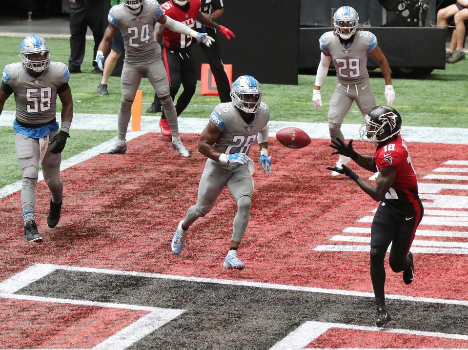 Falcons wide receiver Calvin Ridley gets past Lions safety Duron Harmon to catch a touchdown during the second quarter Sunday, Oct. 25, 2020, in Atlanta.